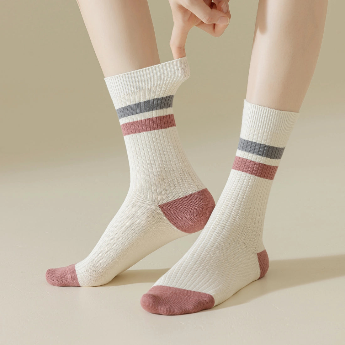 Woman wearing cream cotton socks with burgundy and grey retro stripes – shown on a beige background