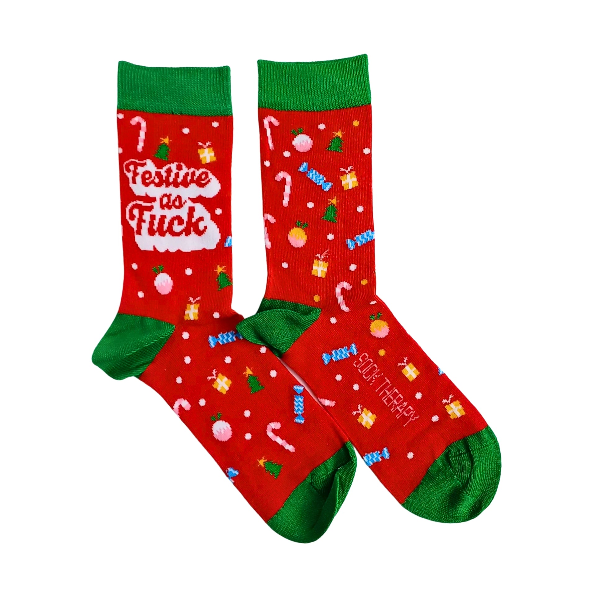 Red novelty socks with green cuffs and toes featuring festive designs and text on a white background
