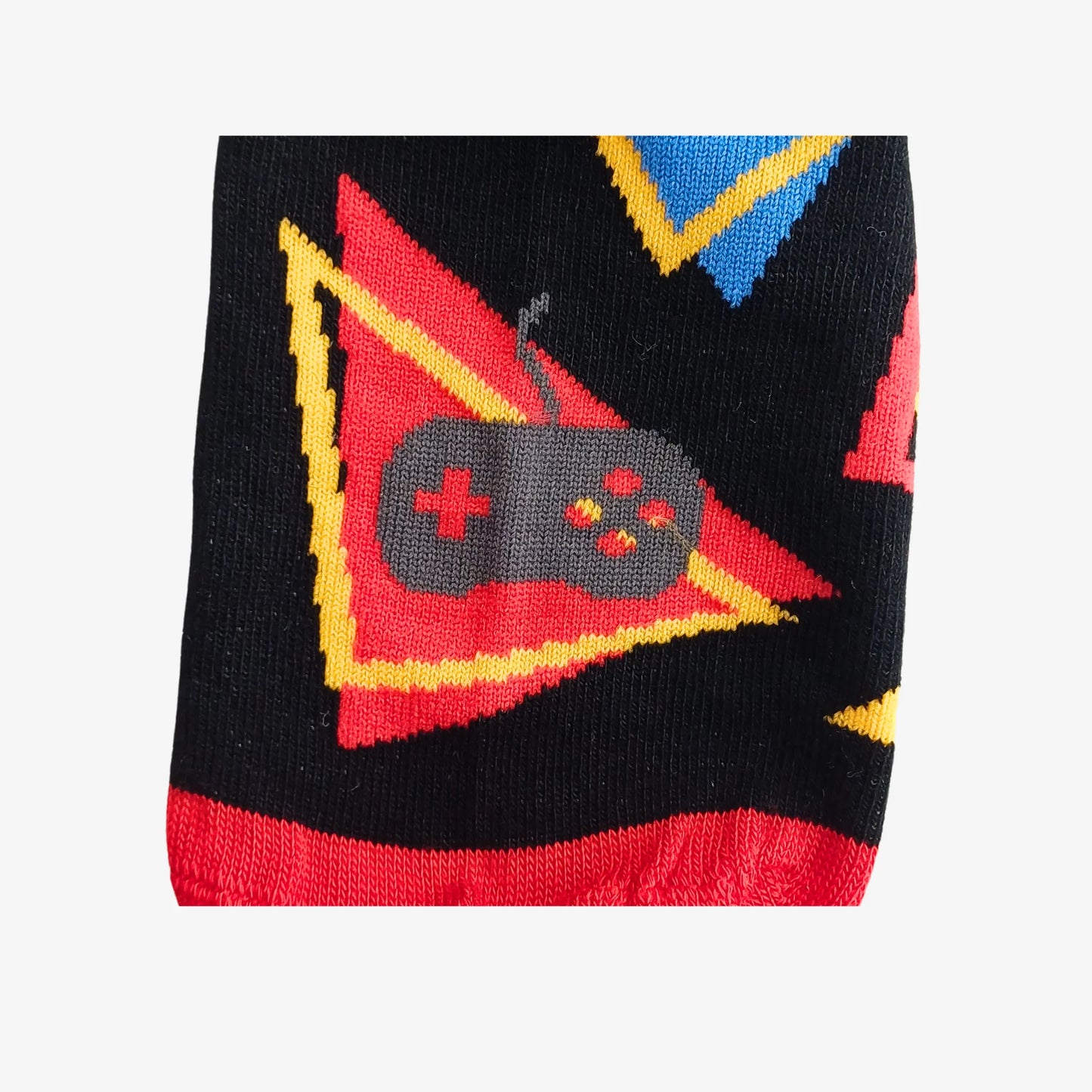 Close-up of novelty bamboo sock with bold red and yellow triangle design featuring a grey video game controller.