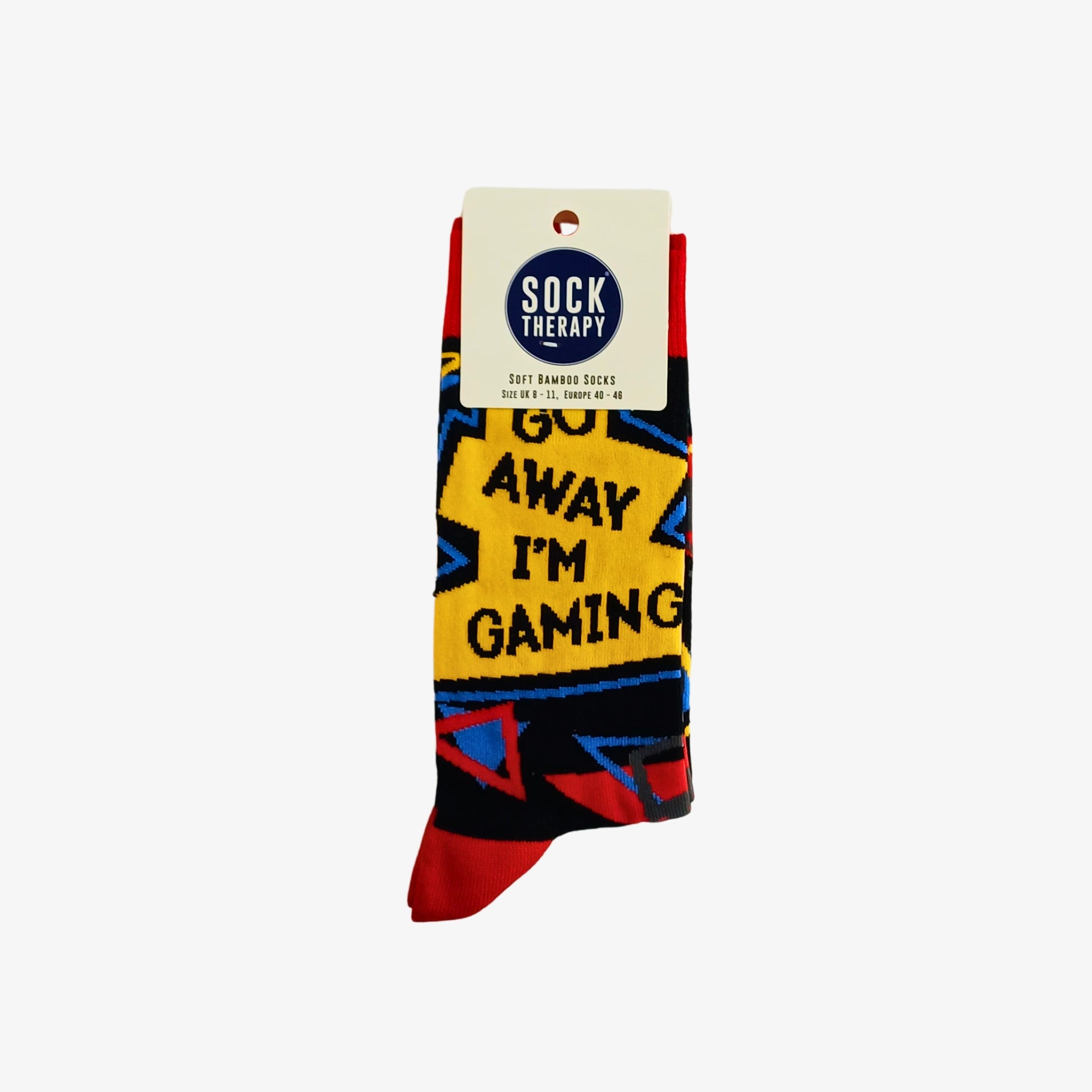 Go Away I’m Gaming bamboo socks folded with Sock Therapy label attached, showing slogan design in bright yellow, red and blue.