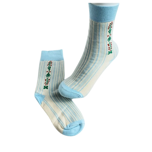 Retro blue floral cotton socks with striped design and embroidery, side view on foot