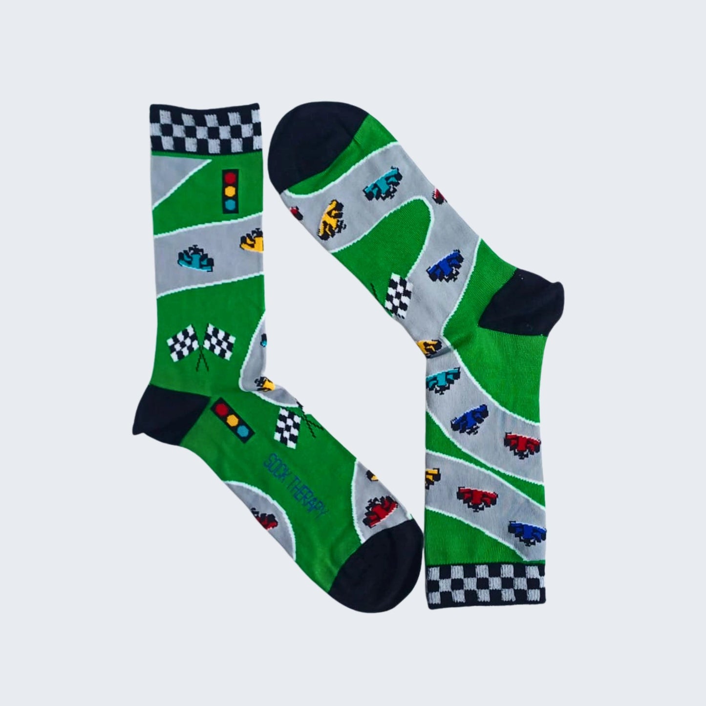 Formula 1 bamboo socks flat lay with race car and chequered flag design on green background