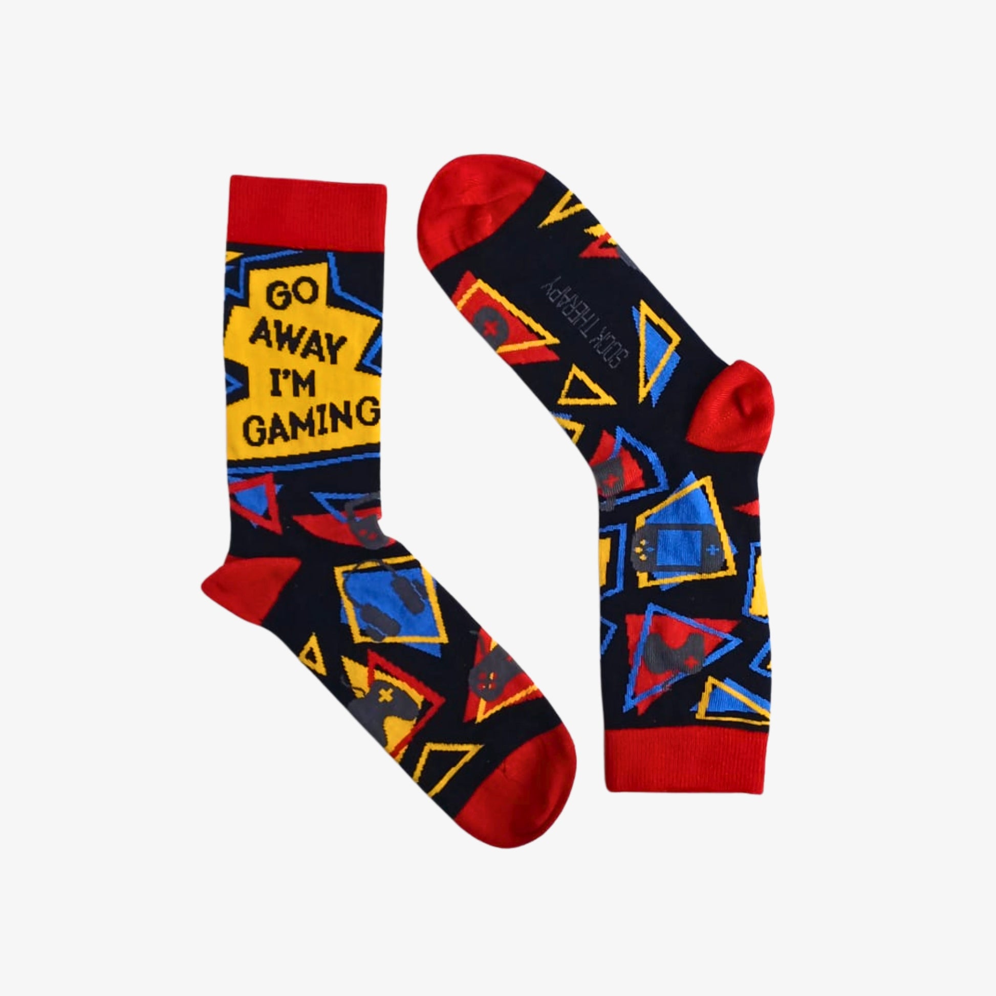 Pair of colourful bamboo socks with red heels and toes, bold geometric patterns in blue, yellow and red, and “Go Away I’m Gaming” text on the leg, displayed flat on a white background.