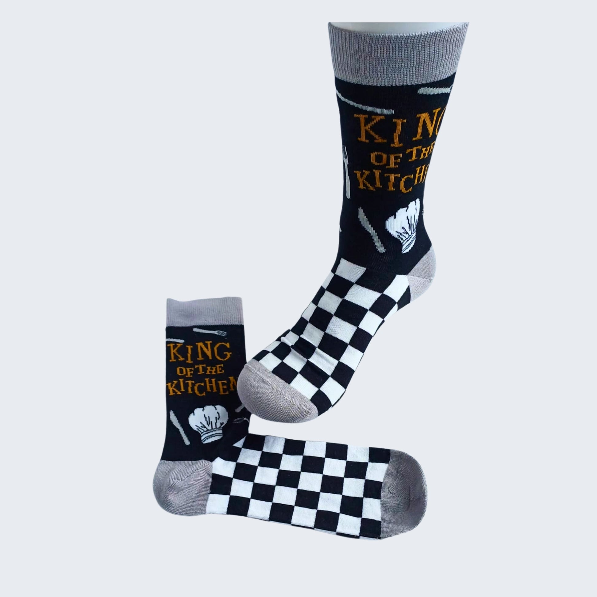 Displayed King of the Kitchen bamboo socks showing chef’s hat and checkerboard pattern
