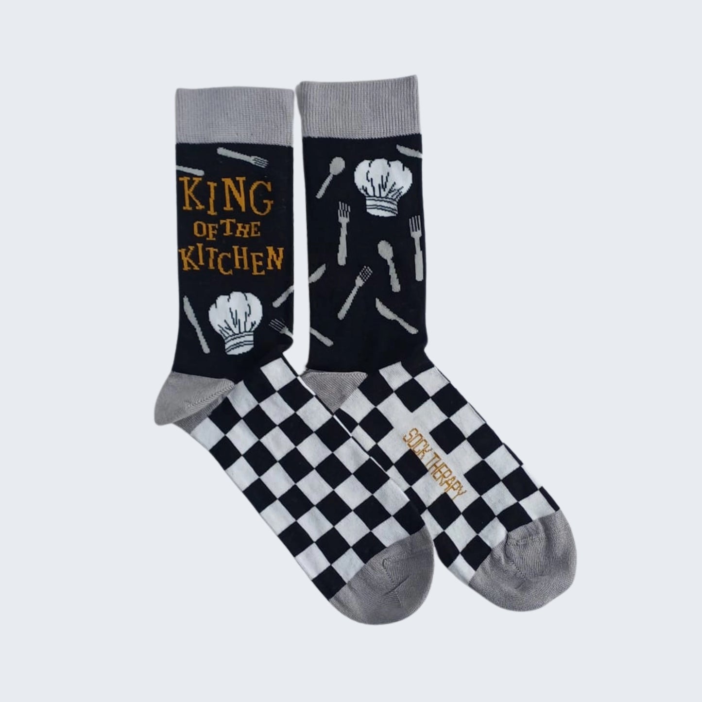 Flat lay of King of the Kitchen bamboo socks with checkerboard design
