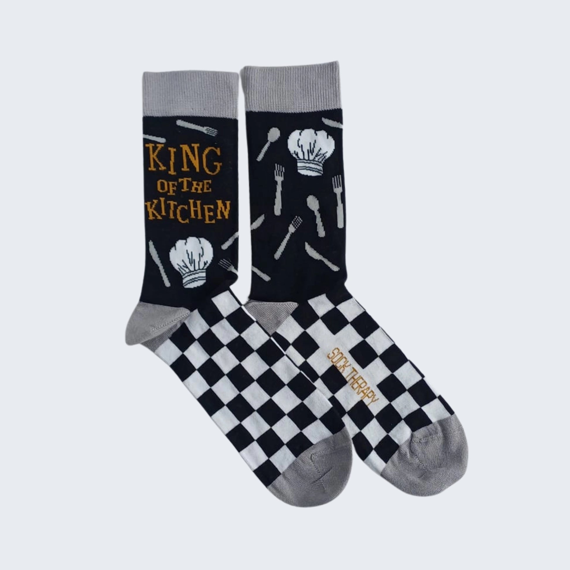 Flat lay of King of the Kitchen bamboo socks with checkerboard design